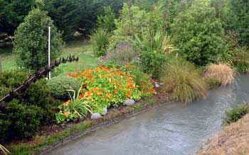 This is a view of the lawn over the water race which used to be visited every spring by a family of ducks. This is a view of the lawn over the water race which used to be visited every spring by a family of ducks.